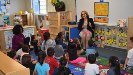 Assembly Member Eloise Gomez Reyes reading to students at Wilson Preschool